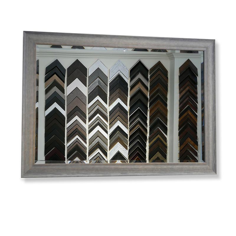 A mirror in a grey frame reflecting various frame samples