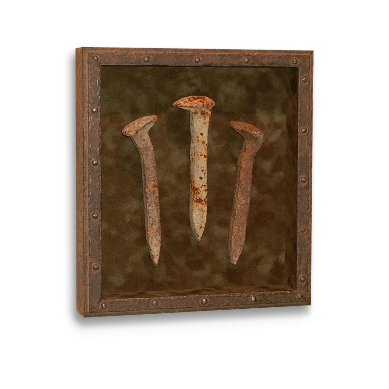 Three old, rusty railway spikes framed in a rusty metalic-looking box with velvet rust colored mat
